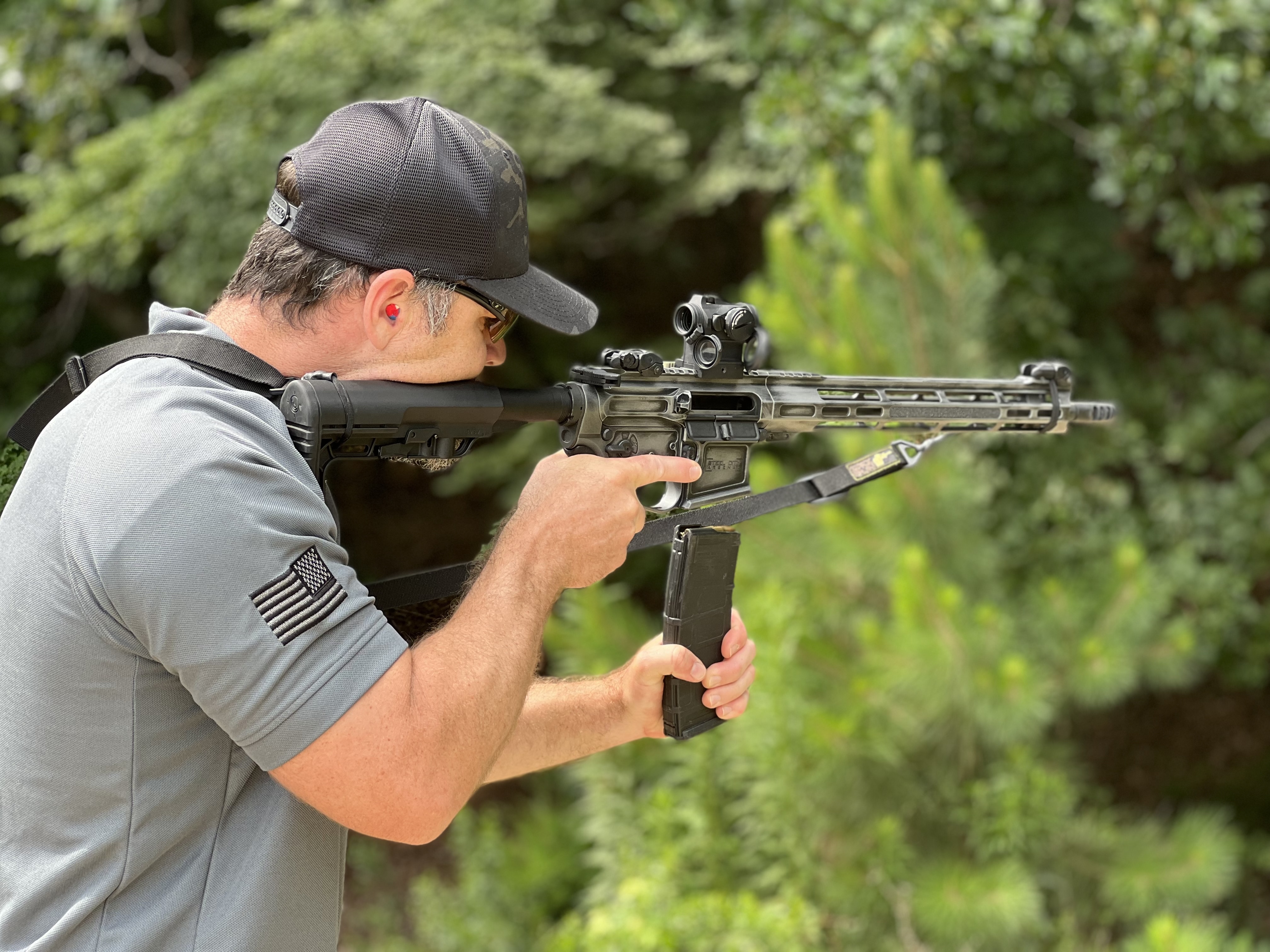 Sean Alcazar shooting a rifle